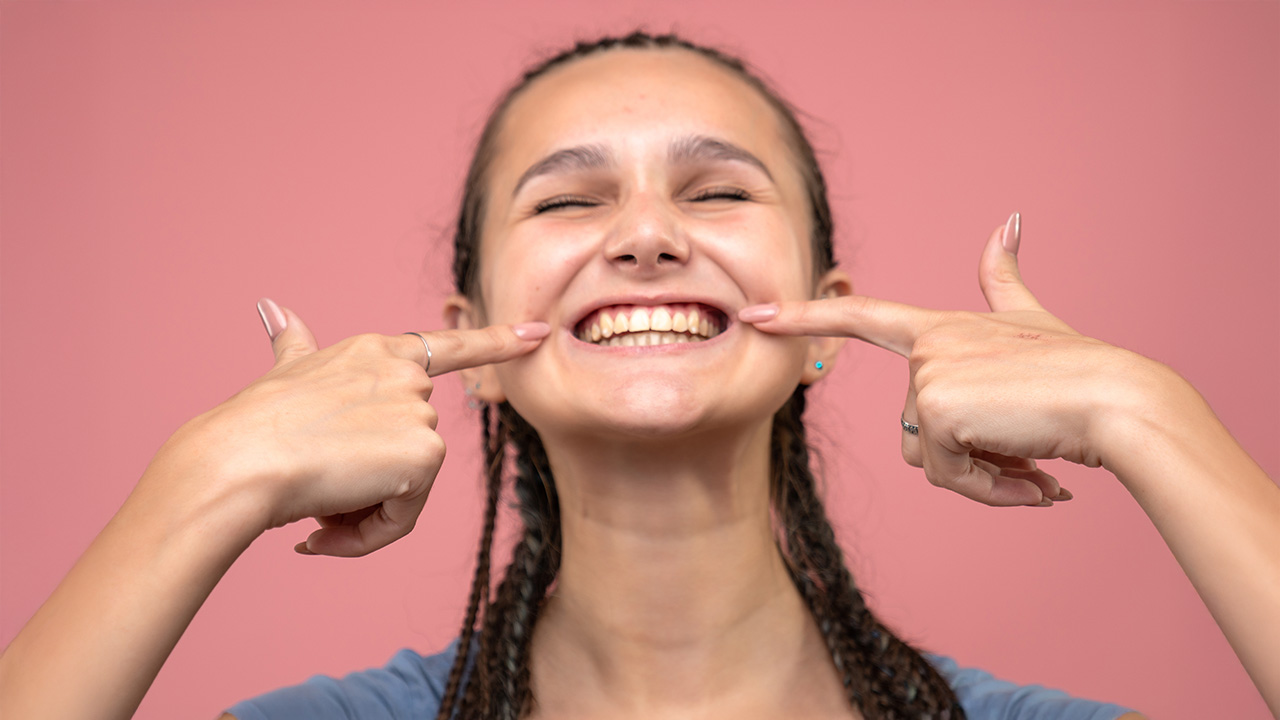 Woman showing her yellow teeth