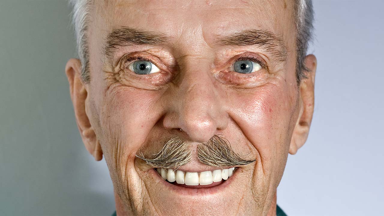 A man showing his teeth to the camera, happy