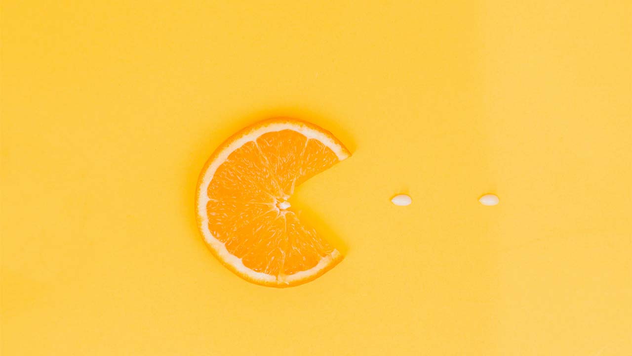 A slide of orange on a yellow surface mimicking the game Pacman.
